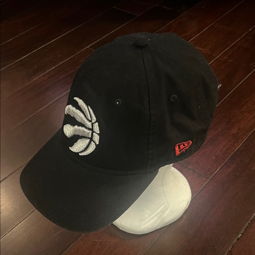 Black Baseball Cap with embroidered White Toronto Raptors Claw logo.